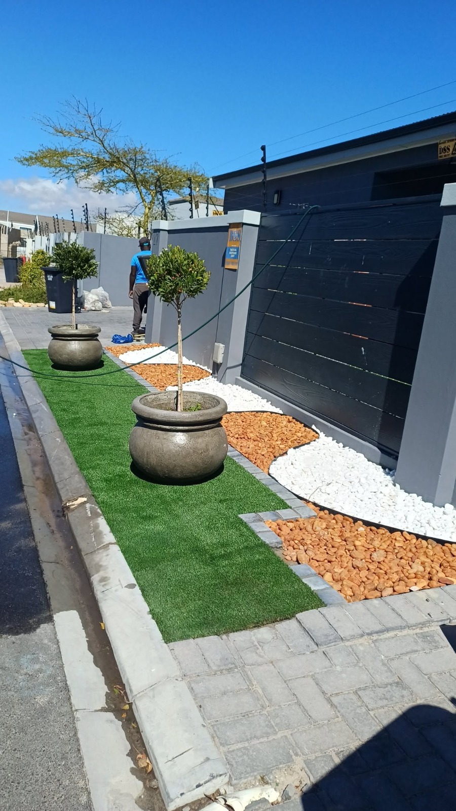 Kerbside landscaping with pebbles & topiary